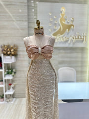 A shimmering, silver, sleeveless gown with a flowing skirt, perfect for a formal event.exclamation